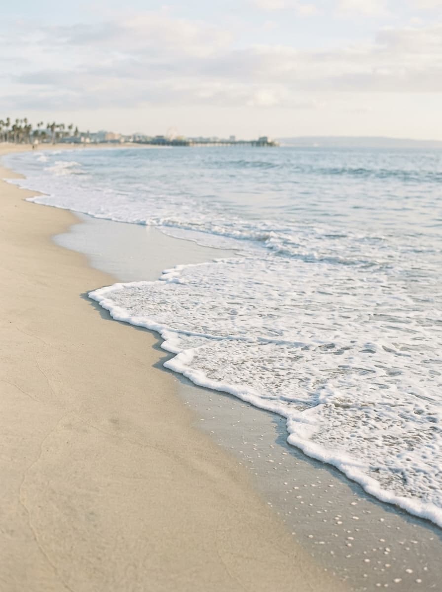Gentle Pacific shoreline wash near Santa Monica, evoking a calm and reflective state