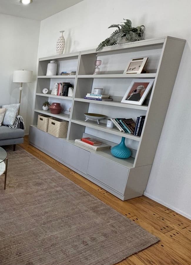 Modern, uncluttered shelving and therapy books in Dr. Maya Reynolds' naturally lit Santa Monica office